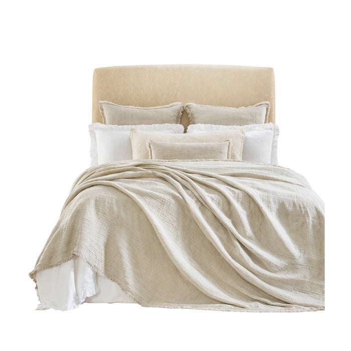 A bed styled with Orchids Lux Home's Dana Beige Coverlet + Shams Collection over crisp white bedding.
