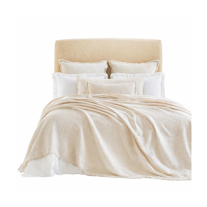The Dana Pearl Coverlet + Shams Collection by Orchids Lux Home features beige bedding with white and beige accent pillows.