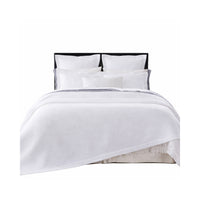 The Hamilton White Matelasse Coverlet + Shams Collection by Orchids Lux Home features white diamond quilting and four pillows.