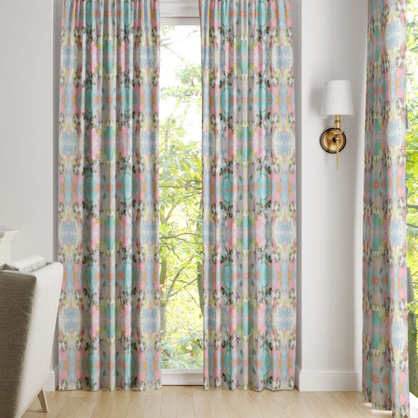 Brooks Avenue Curtain Panels by Laura Park Designs frame a bright window, adding joyful color to a lively scene.