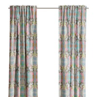 Brooks Avenue Curtain Panels by Laura Park Designs frame a bright window, adding joyful color to a lively scene.