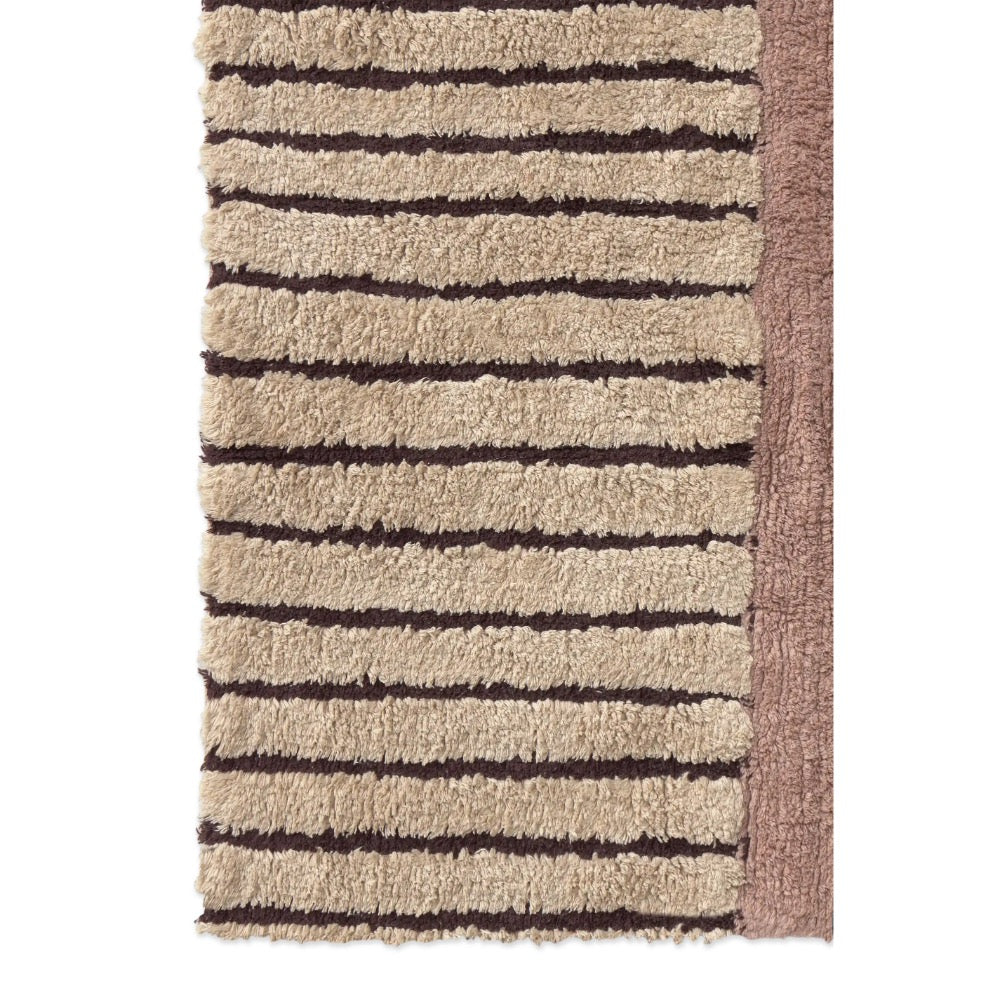 A close-up of a textured rug with horizontal beige and dark brown stripes and a solid brown side border, shown against a plain white background.
