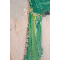 close up of green scarf and beige shirt on a textured surface