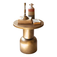 Small round table with a gold base and wooden top, featuring books and a vase on a white background.