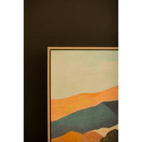 Abstract landscape painting with orange, green, and brown hues in a black frame.
