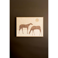 Framed artwork of two horses on a dark brown wall