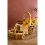 Kalalou Driftwood Baskets with Handles are displayed on a recycled driftwood table against a warm-toned background.