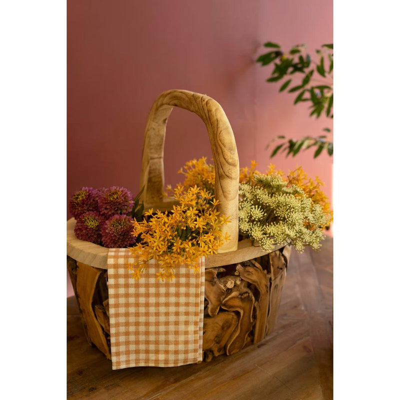 Kalalou Driftwood Basket with Handle: filled with pink, yellow, & white flowers, checkered cloth draped on the side.