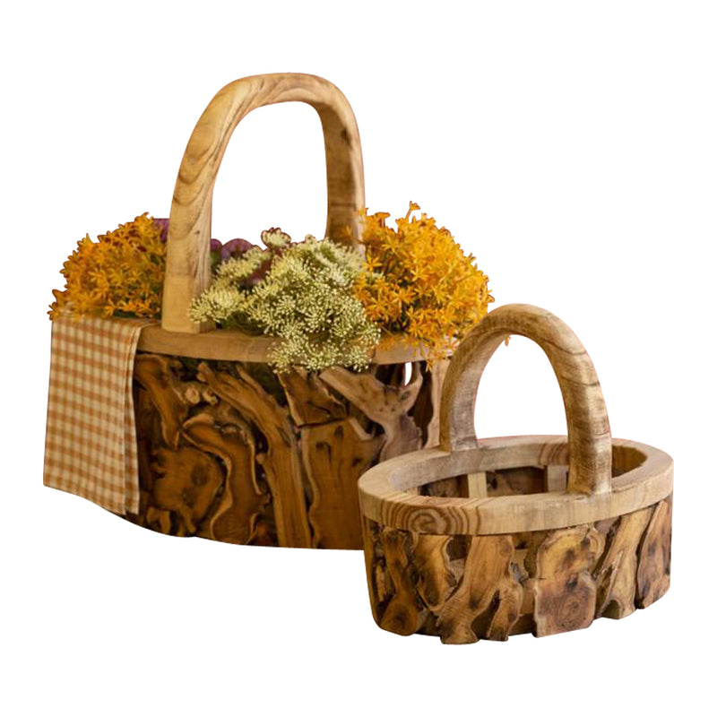 Two Kalalou Driftwood Baskets with Handles filled with flowers.