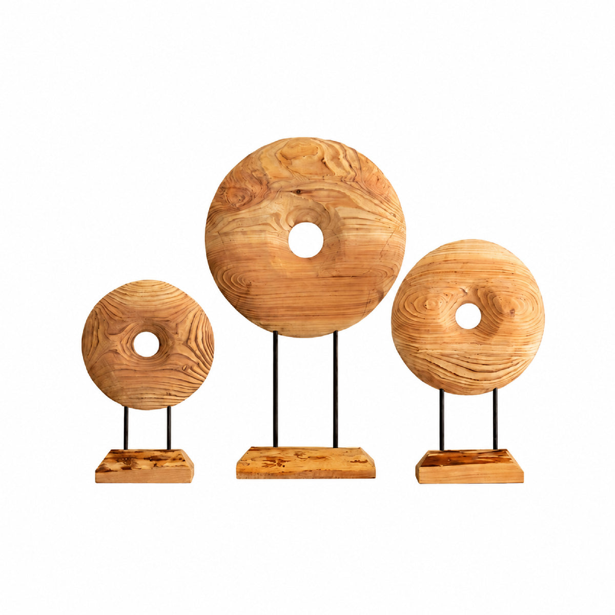 Three rustic wooden donut-shaped decorative sculptures of different sizes, each mounted on a black metal stand with a rectangular wooden base, arranged against a plain white background.