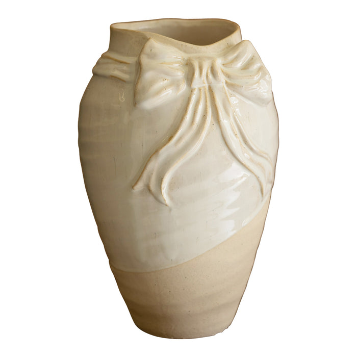 Beige ceramic vase with a decorative bow design on a white background