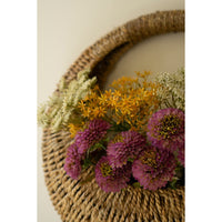 Kalalou's Woven Vine Wall Basket set showcases purple, yellow, and white flowers as charming natural decor.