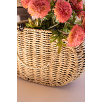 Woven basket with pink flowers on a white background