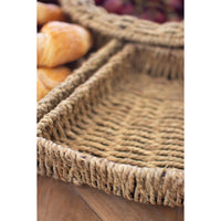 Woven basket with bread and fruits on a wooden surface