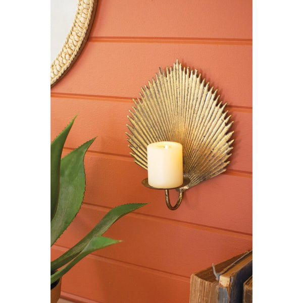 Decorative wall sconce with a candle on a red wall