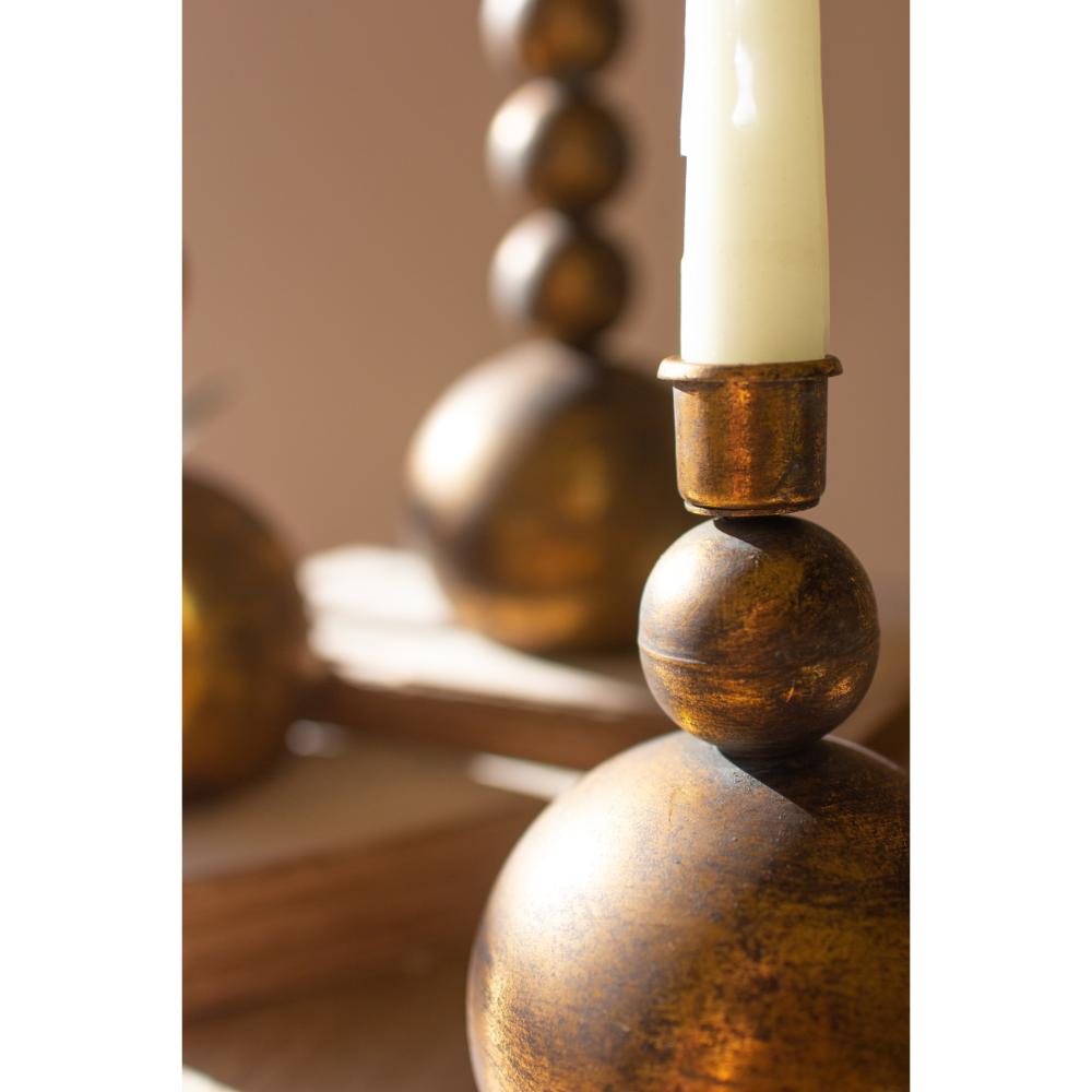 Decorative candle holder with a candle on a wooden surface