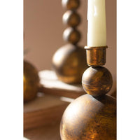 Decorative candle holder with a candle on a wooden surface