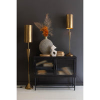 Black cabinet with gold lamps against a dark wall