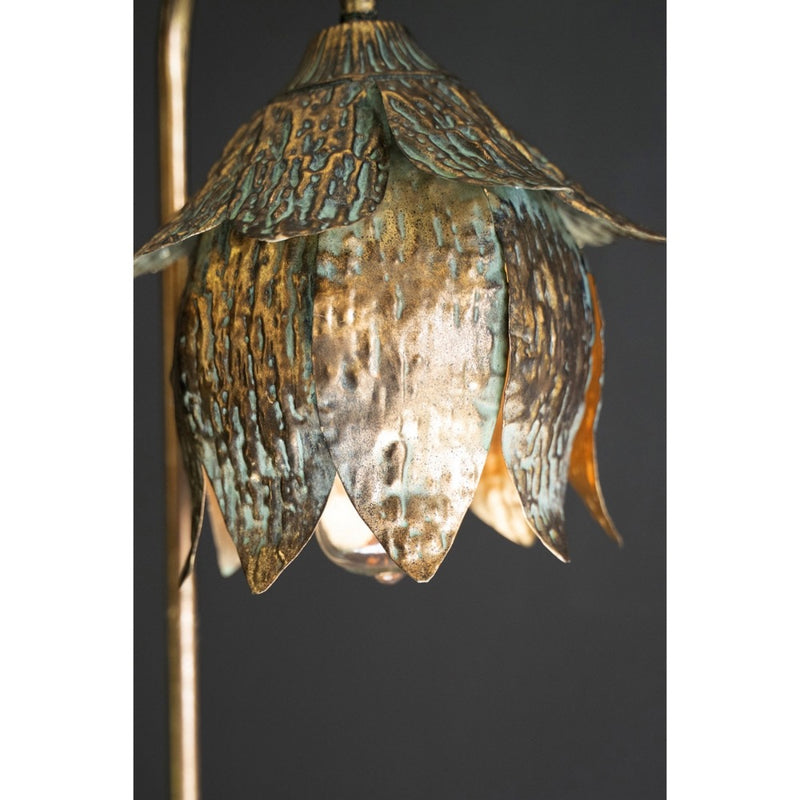 Close-up of Kalalou's Antique Brass Tulip Table Lamp with layered petals against a dark background.