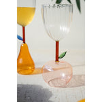 Kalalou's Apple Base Wine Glasses (set of 6) with leaf details are perfect for your home bar on a textured white surface.