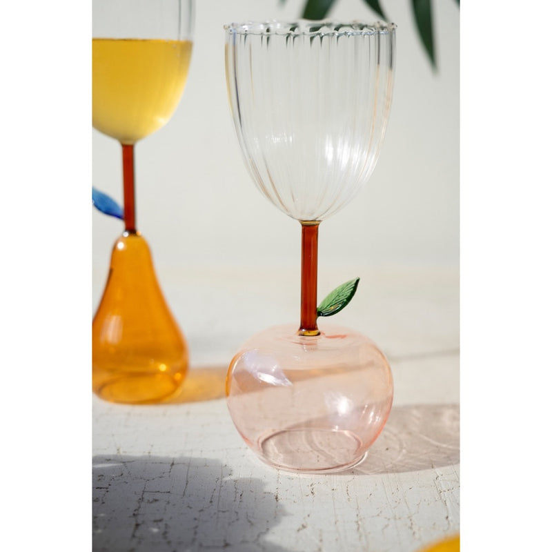 Kalalou's Apple Base Wine Glasses (set of 6) with leaf details are perfect for your home bar on a textured white surface.