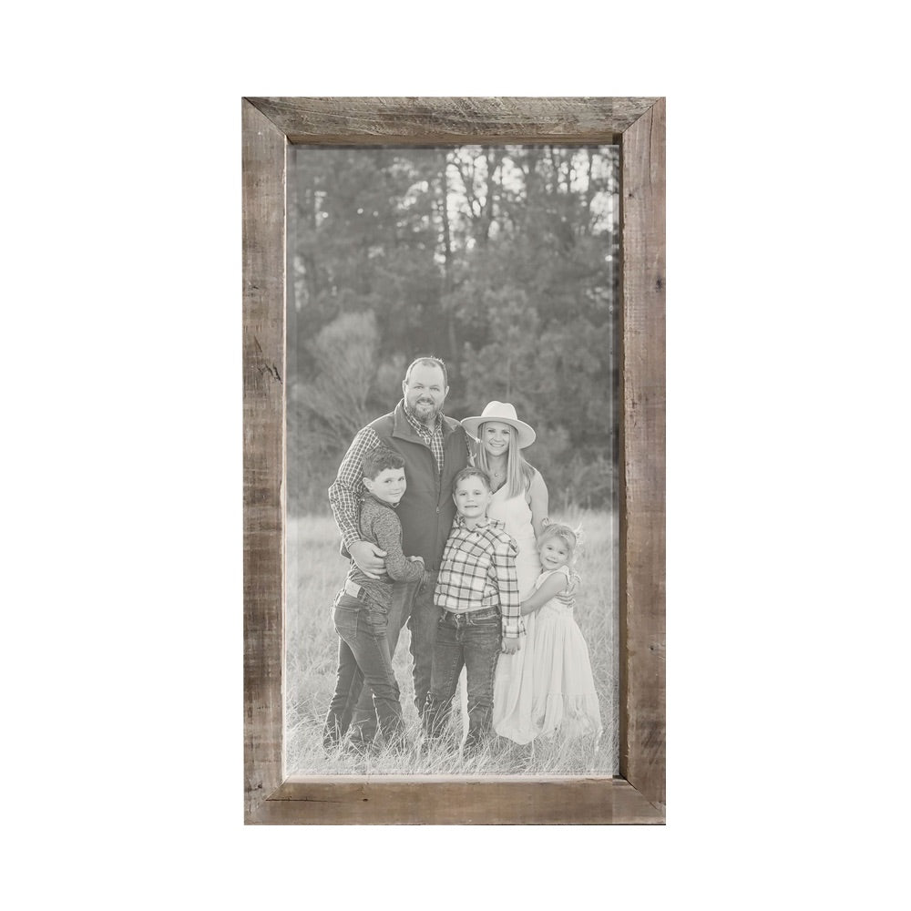 A family photo in black-and-white featuring parents and three children, beautifully displayed in the Brayden & Brooks Timberwood Frame Custom Photo Panel, standing in a field.