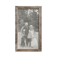 A family photo in black-and-white featuring parents and three children, beautifully displayed in the Brayden & Brooks Timberwood Frame Custom Photo Panel, standing in a field.