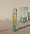 Green glass with a drink on a textured surface