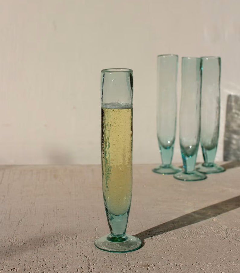 Green glass with a drink on a textured surface