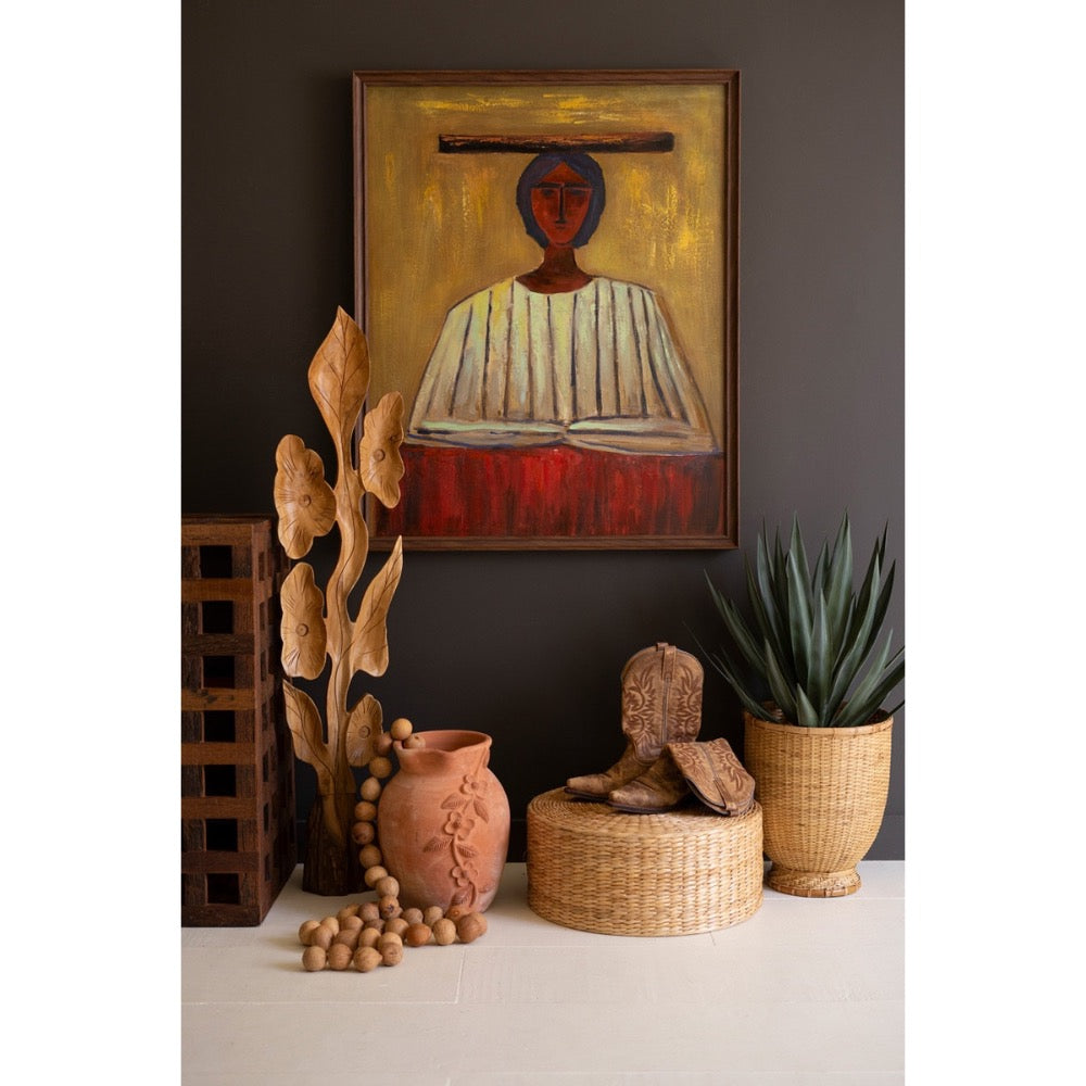 Decorative setting with a painting, sculptures, and plants against a dark wall.