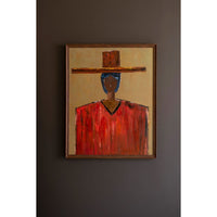 Framed artwork of a person wearing a red shirt and hat on a dark wall