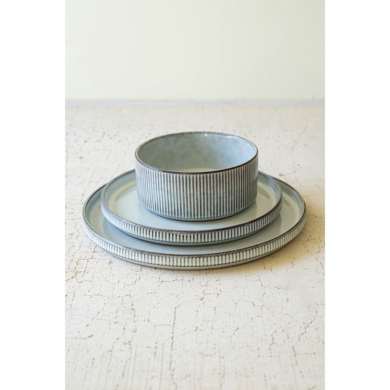 Three dishes from Kalalou's Glacier Ceramic Dinner Collection on a textured surface.