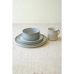 Kalalou's Glacier Ceramic Dinner Collection: Ribbed textured set with bowl, plates & cup on a light surface.