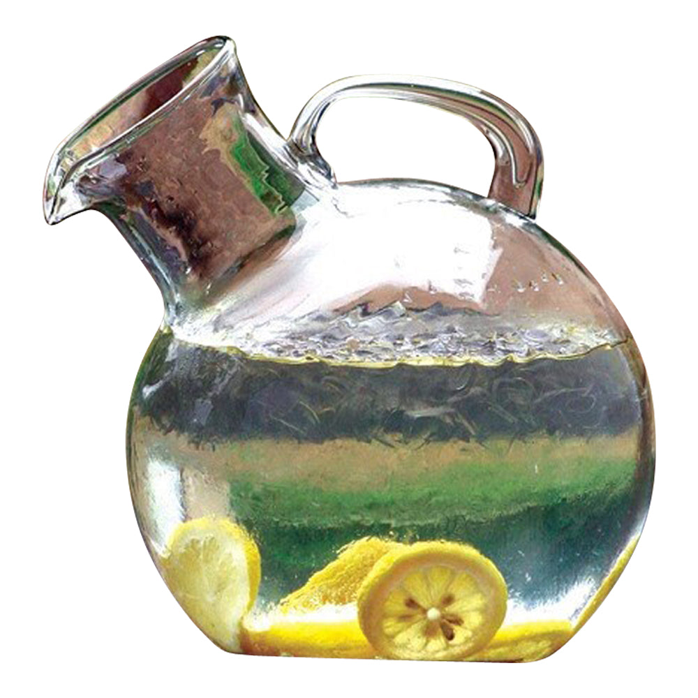 Clear glass pitcher with lemon slices inside on a white background