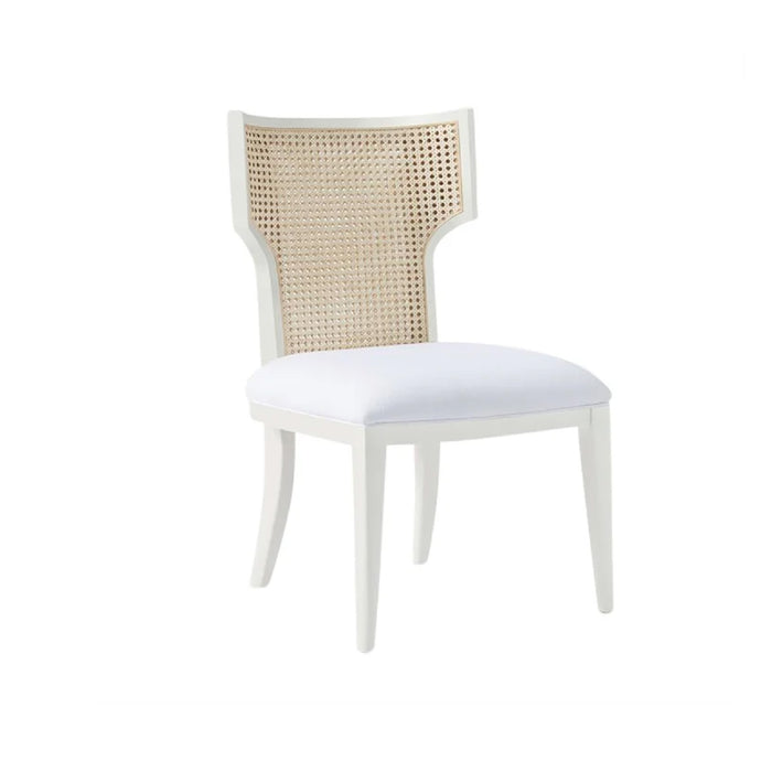 The Carleen Glossy White + Natural Cane Chair by Made Goods features a woven cane back and white fabric seat.