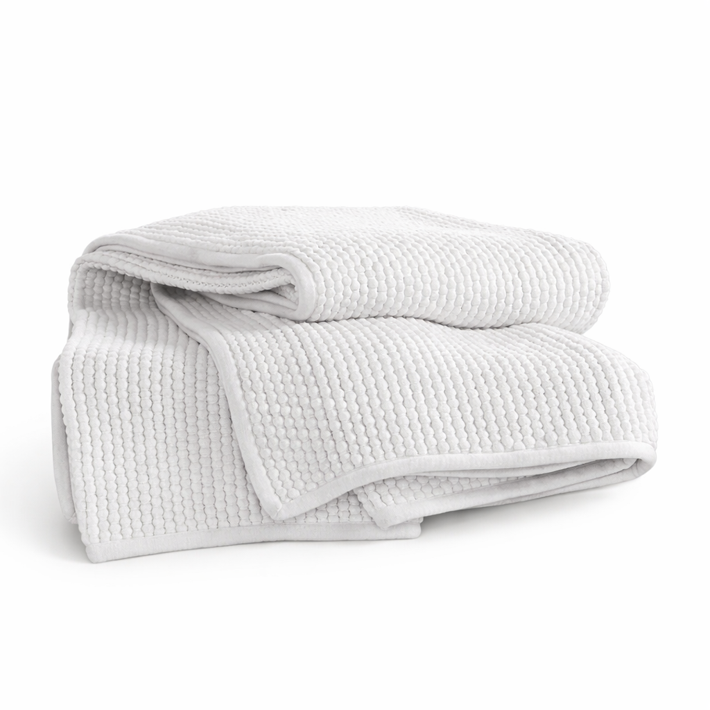 The White Mandalay Popcorn Throw by India's Heritage is a 100% cotton, breathable white throw on a plain background.