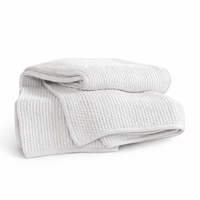 The White Mandalay Popcorn Throw by India's Heritage is a 100% cotton, breathable white throw on a plain background.