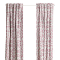 Chintz Rose Curtain Panels by Laura Park Designs, in pink and white, hang before a window with tree views.