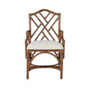 The Chippendale Arm Dining Chair by Kenian features a geometric lattice backrest, a white seat cushion, and a tortoise finish.