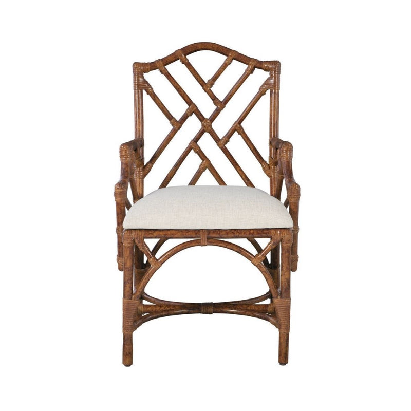 The Chippendale Arm Dining Chair by Kenian features a geometric lattice backrest, a white seat cushion, and a tortoise finish.