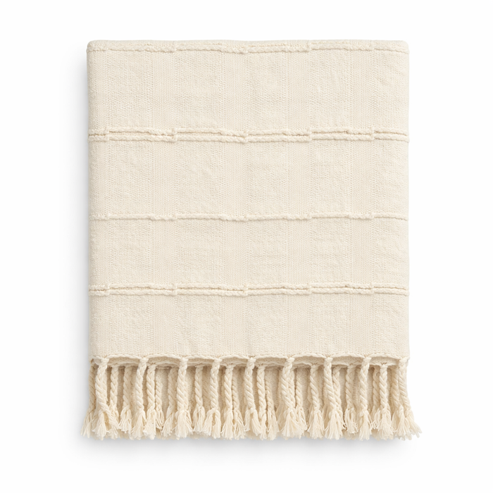 Creative Co-Op Cotton Blend Textured Throw, cream-colored with stripes and fringed tassels, folded neatly.
