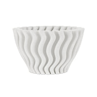 White ceramic bowl with wavy design on a white background
