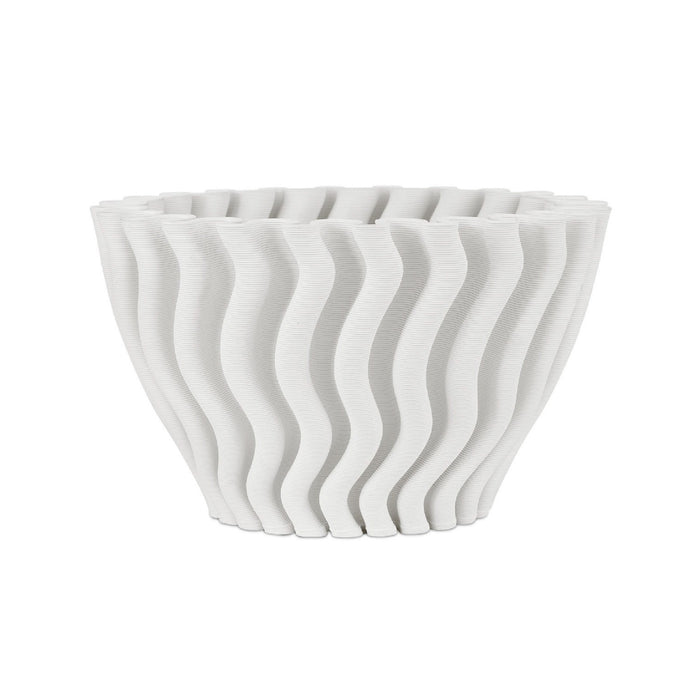 White ceramic bowl with wavy design on a white background