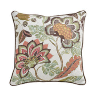 A square decorative throw pillow with a detailed botanical pattern featuring large flowers and leaves in muted green, rust red, brown, and peach tones on an off-white background, finished with a dark brown piped edge.