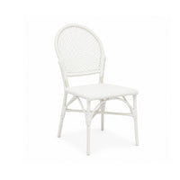 The Donovan White Faux Rattan Indoor/Outdoor Chair by Made Goods features a rounded back and woven seat, perfect for patios.