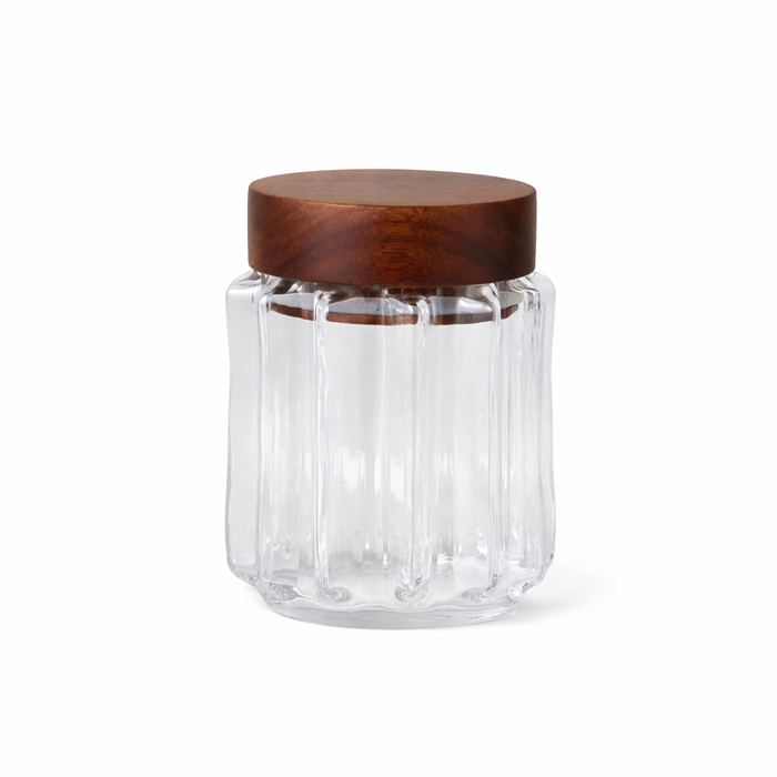 Clear glass jar with a wooden lid on a white background