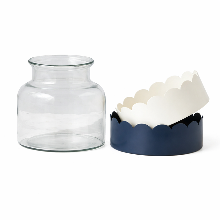 Clear glass jar next to a scalloped edged bases navy and white