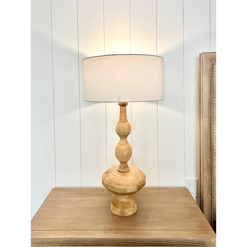 wood carved table lamp with shade on nightstand
