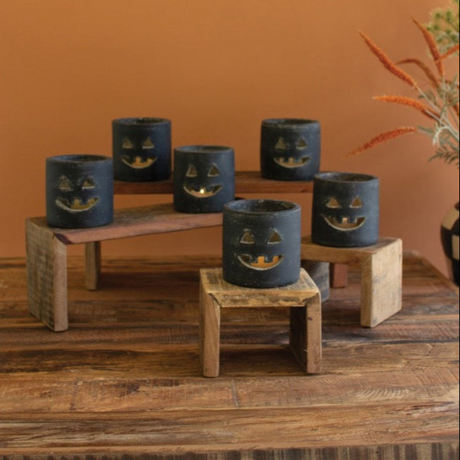 Set of 6 Kalalou Short Black Clay Jack-O-Lanterns on stands, great for indoor/outdoor Halloween décor.