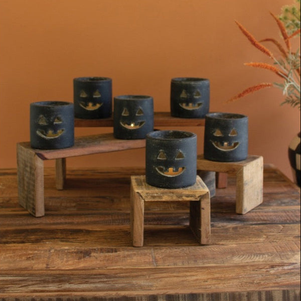 Set of 6 Kalalou Short Black Clay Jack-O-Lanterns on stands, great for indoor/outdoor Halloween décor.